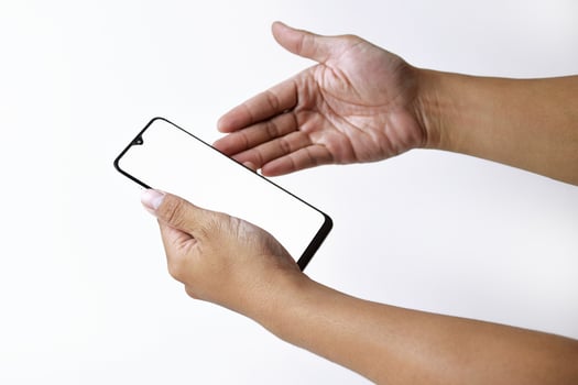 Male hand shows the screen of a mobile smartphone which has a white screen photo