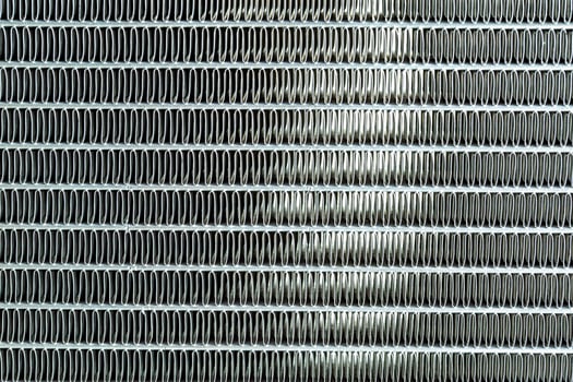 Texture of a honeycomb of an automotive aluminum car cooling radiator, close-up. photo