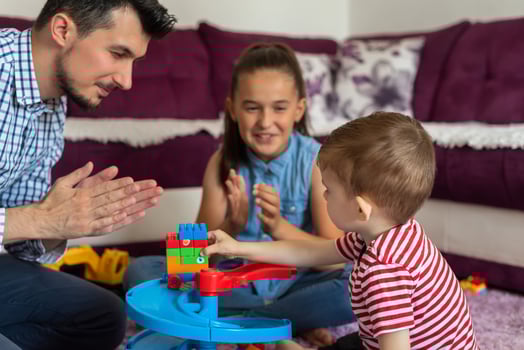 Happy family playing together with toys on the floor in the living room. photo