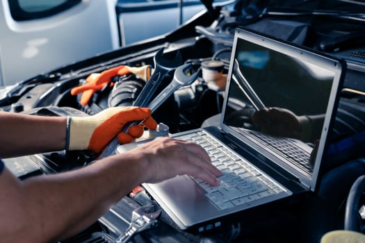 Car inspection service using a modern computer system. and a modern mechanic in the garage Auto mechanics use computer software to check two engines are running and repair them. photo
