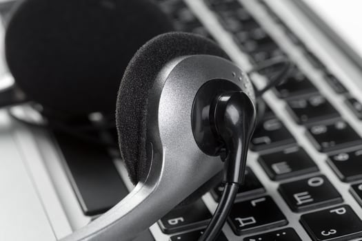 call center support concept. headset on keyboard computer laptop photo