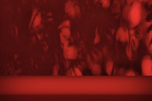 Stucco Table with Bokeh Light and Shadow of Christmas Trees in the Christmas Red Tone photo