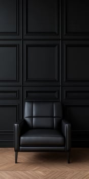 Stylish black leather chair in modern room with dark wall panels photo