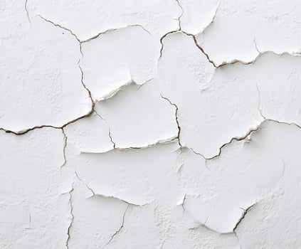Cracked white wall texture revealing age and wear over time photo