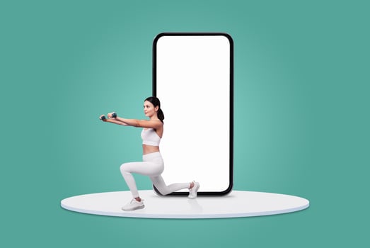 A woman in activewear performs a lunge with dumbbells while facing a large blank mobile device. The setting is bright and modern, showcasing a focus on fitness and technology. photo