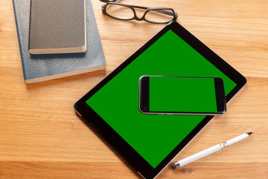 Smartphone and digital tablet on wooden desk photo