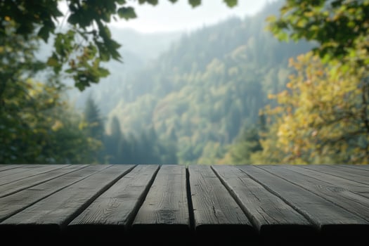 A tranquil forest view from a wooden deck during a misty morning photo