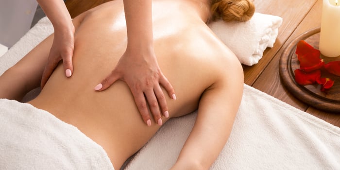 Spa body massage with oil on back of woman photo