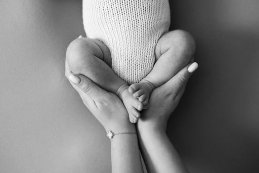 A black and white photo of a baby's feet