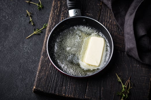 Melted butter on in iron pan photo