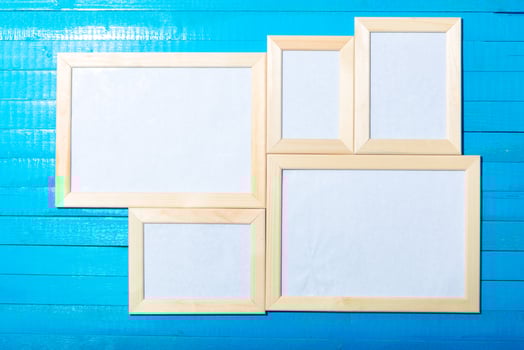 photo frames on the wooden wall