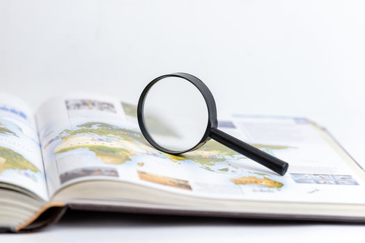 Magnifying glass on open book symbolizing search, research, and in-depth exploration of knowledge and information, emphasizing discovery and detailed analysis in learning and studying contexts photo