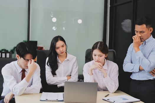 Frustrated upset multiracial business team people sad with bad work result in report disappointed in corporate bankruptcy failure crisis worried of paperwork problem sit at table at office meeting photo