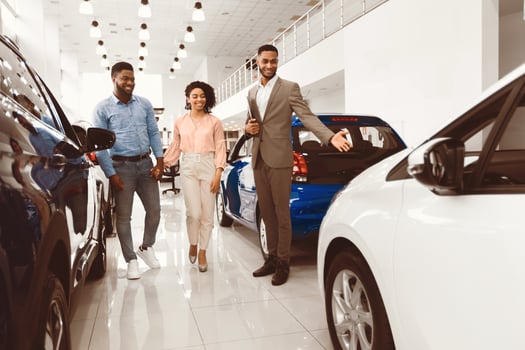 Automobile Seller Showing Luxury Car Consulting Couple Choosing Auto In Dealership Shop. Buying Vehicle Concept photo