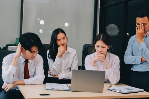 Frustrated upset multiracial business team people sad with bad work result in report disappointed in corporate bankruptcy failure crisis worried of paperwork problem sit at table at office meeting photo