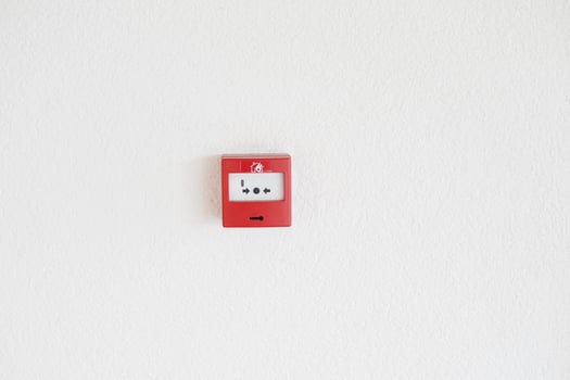 Red fire alarm button on wall , photo