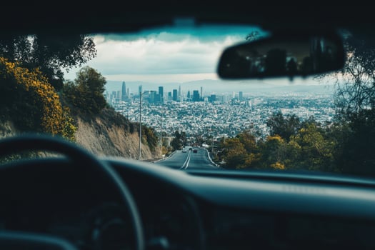 View of a city skyline through the windshield of a car. photo