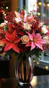 Christmas flower arrangement with red poinsettia, roses and berries in elegant vase photo