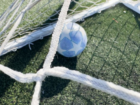 Soccer ball on a grass football field photo