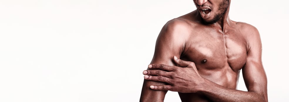 Unrecognizable Sportsman Suffering From Pain In Biceps Muscles Standing Over White Background. Studio Shot, Cropped photo