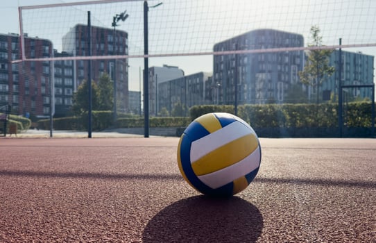 A volley ball is placed on a floor photo