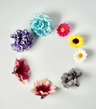 Decorative colorful small flowers frame border display object isolated on vertical copy spaced white background. photo