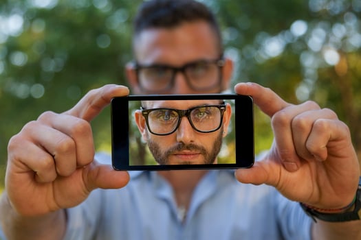 handsome young man take a selfie with smart phone photo
