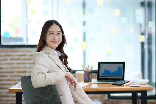 Confident businesswoman sitting in a modern office with a smile photo