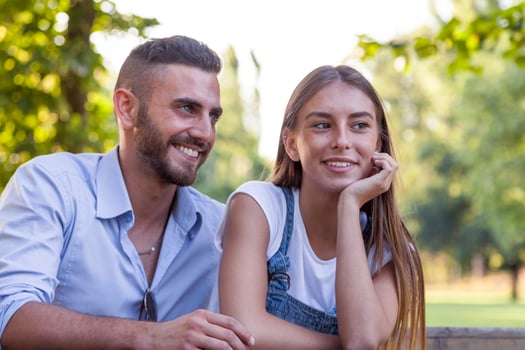 beautiful couple of young adults relaxing in the park photo