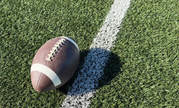 Pro American Football on the Field Close Up with Yard Lines Beyond photo