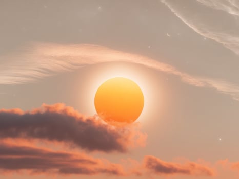 The sun is seen in the sky above clouds photo