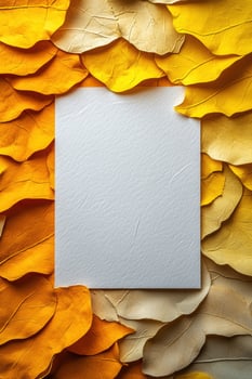 blank white page surrounded by vibrant yellow and beige leaves creates warm, inviting atmosphere perfect for autumn themed designs photo