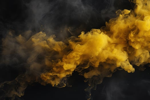 Dramatic yellow smoke cloud against black background photo