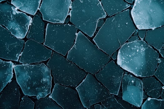 Icy winter landscape with cracked frozen lake surface photo