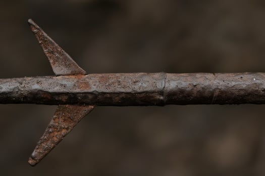 Rusty old metal nail on a dark background photo