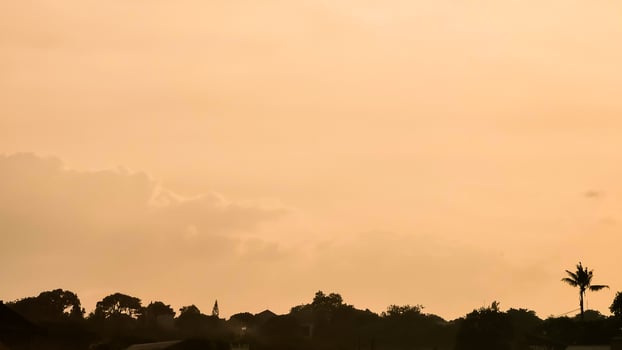 A silhouette of a plane flying over a city photo