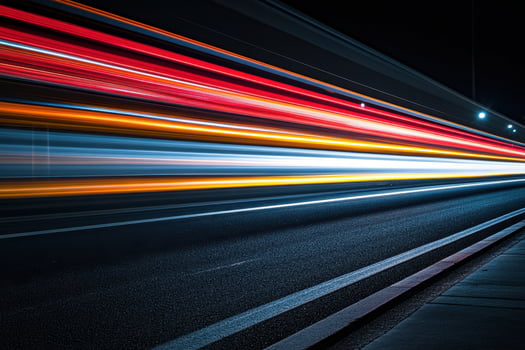 Abstract light trails of moving cars on a dark road at night. photo