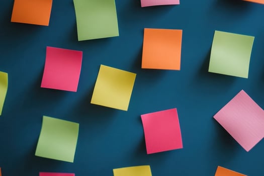 Colorful sticky notes scattered on a blue background. photo