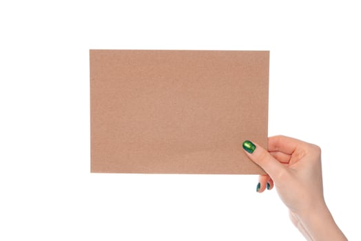 Craft paper card in female hand isolated on white photo