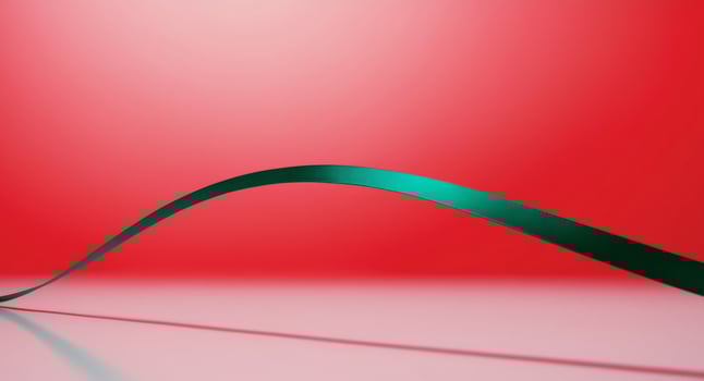 A curved green ribbon on a red background photo