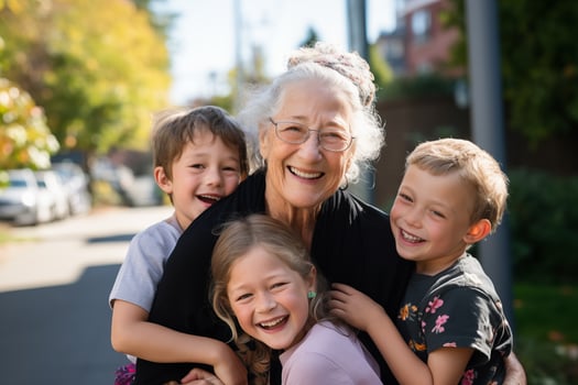 Caucasian granny with glasses smiles surrounded by her grandchildren who laugh, lifestyle on the street photo