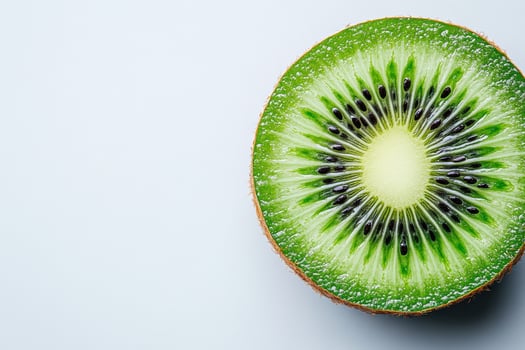 Fresh ripe kiwi sliced in half, showcasing vibrant green flesh and black seeds, perfect for healthy snacks or smoothies photo