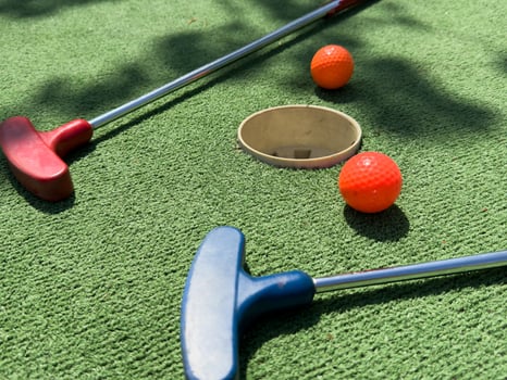 Closeup of player play mini golf with ball photo