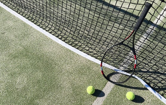 Top view of tennis rackets and ball of green grass. Horizontal sport poster, greeting cards, headers, website photo