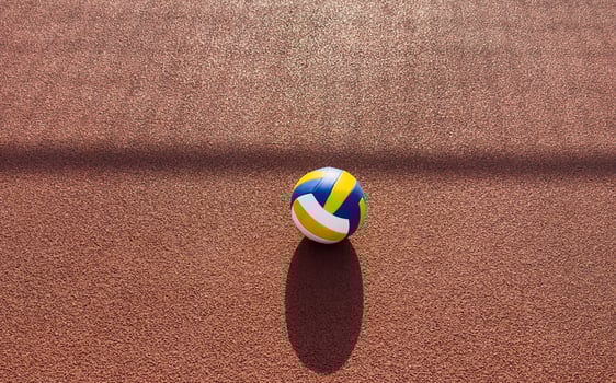 volleyball. blue with yellow color ball on the playground. volleyball cover, red. ball game photo