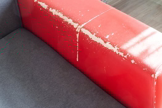 Torn and battered leather back of the sofa. Poor quality leather, leather cleansing and restoration photo