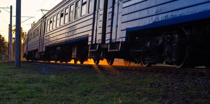 Passenger train electric train on the background of a sunny sunset, evening time. Railroad passenger transportation concept, copy space for text photo