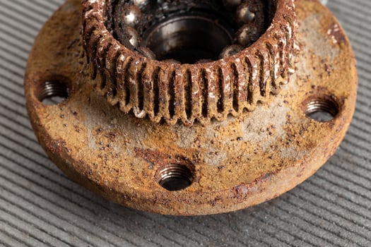 Old rusty wheel hub with a broken bearing. Bearing jamming. Automotive Part, close-up. photo