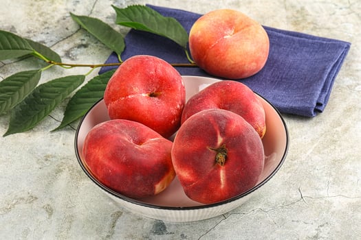 Ripe sweet and juicy Flat peach photo