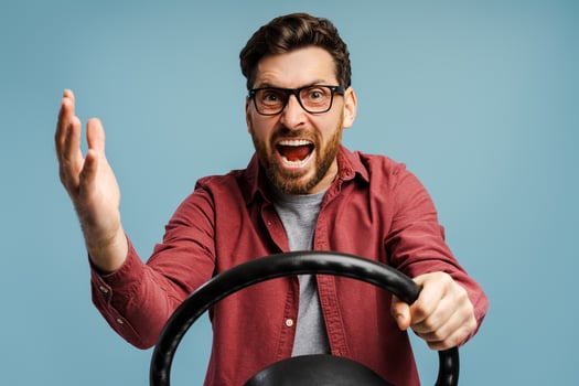 Portrait of negative, angry bearded Latin man wearing eyeglasses holding helm, shouting, gesturing photo